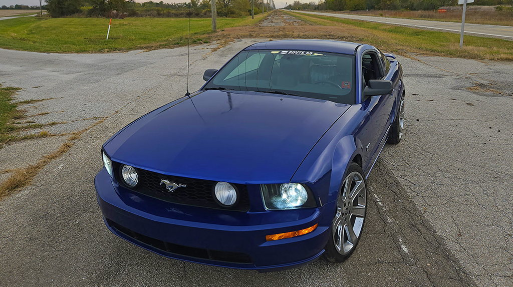 Front three quarter view of a 2005 Ford Mustang GT parked along old Route 66 in Illinois