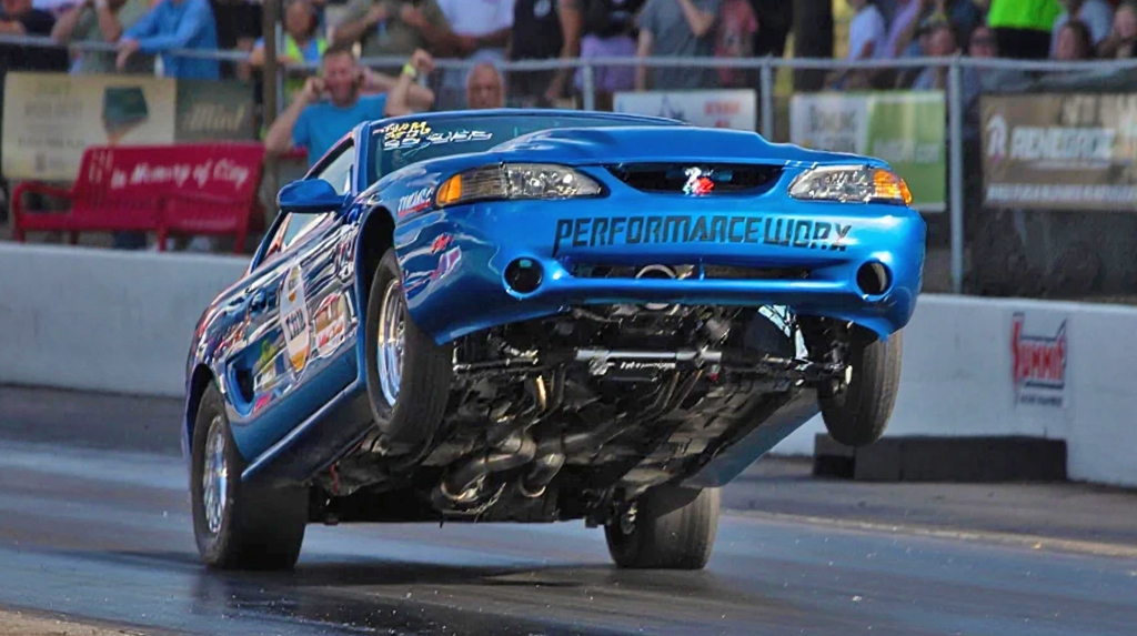 Matt Fint 1998 Ford Mustang Cobra racing int he TREMEC Stick Shift Shootout at the 2025 Holley Ford Fest